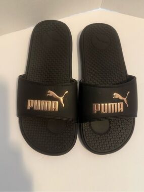 Puma Black Slides with Metallic Rose Logo